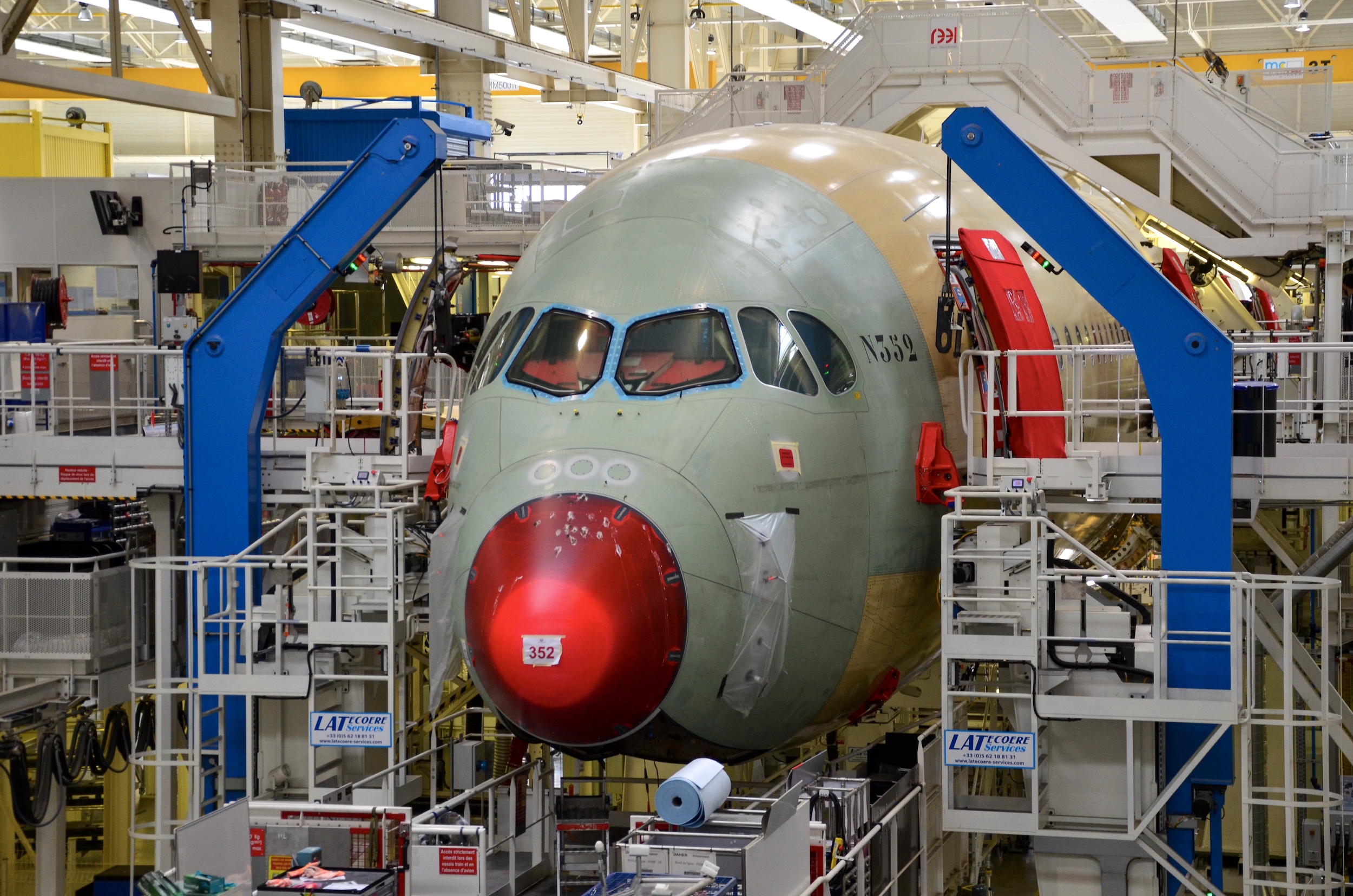 An earlier Japan Airlines A350-900 undergoing final assembly with Airbus in Toulouse in 2019. The green material that makes up the jet's forward fuselage is aluminum lithium while the tan material is panelized carbon fiber reinforced polymer that is built up into the fuselage.