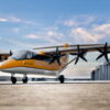 Rendering of Electra EL9 ultra-STOL aircraft sitting on airport ramp against a blue sky with wispy clouds