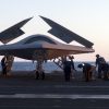 An X-47B Unmanned Combat Air System demonstrator is loaded on an aircraft elevator aboard the aircraft carrier USS George H.W. Bush (CVN 77)