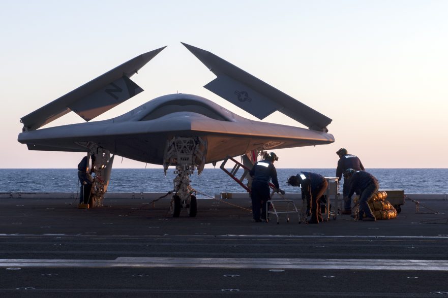 An X-47B Unmanned Combat Air System demonstrator is loaded on an aircraft elevator aboard the aircraft carrier USS George H.W. Bush (CVN 77)